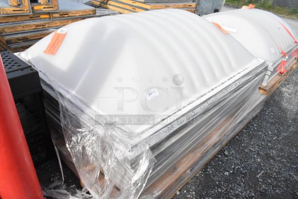 Stack of 5 white dome covers, packaged on a pallet with plastic wrap. Visible tags show inventory numbers.