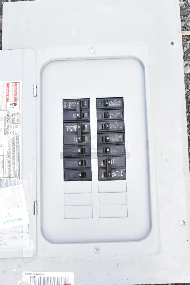 Gray metal electrical box with multiple circuit breakers. Visible labels indicate safety warnings and specifications. Good condition.
