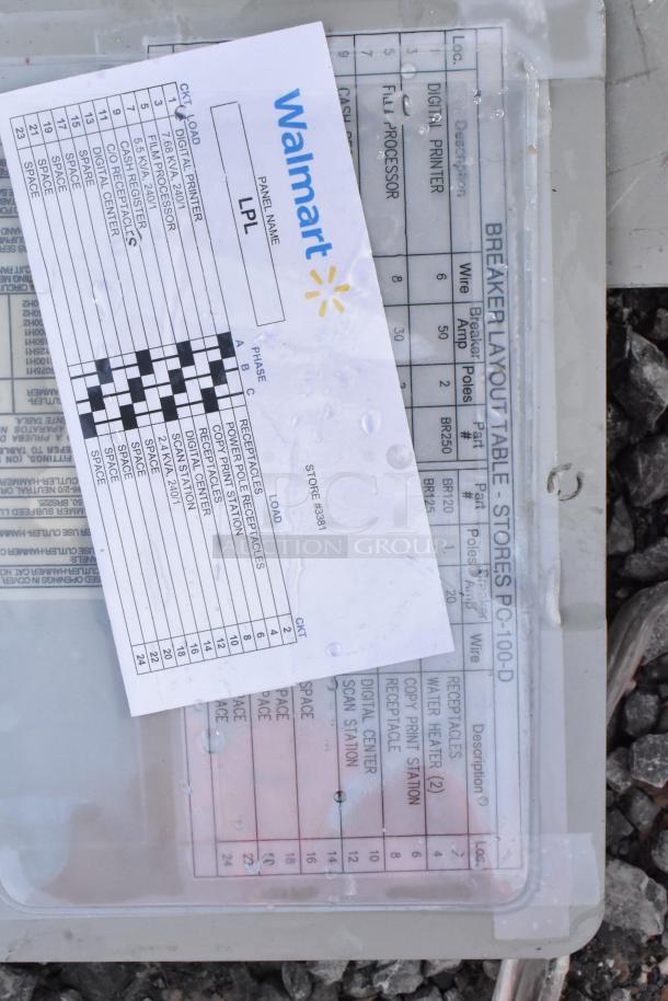 Gray metal electrical box with visible breaker layout table and a form labeled "Walmart" for store #5381. Tags list circuit information.