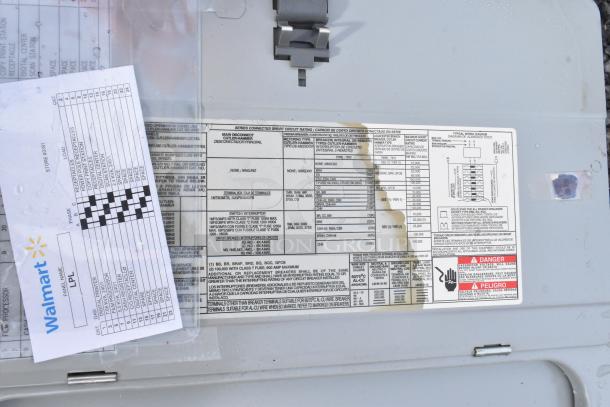 Gray Metal Electrical Box with wiring diagram and safety labels. Visible markings include specifications and a retailer document. Slight wear observed.