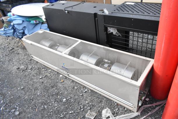 Berner FSA-2-72 metal air curtain, 120V, 1 phase, gray finish, visible logo, mesh cover, industrial setting.