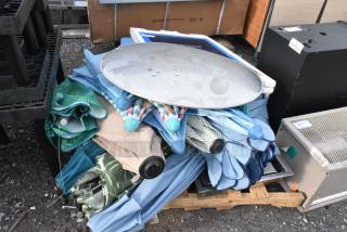 Pallet of assorted items, including colorful umbrellas and a metal tray, in used condition. Various fabrics visible.