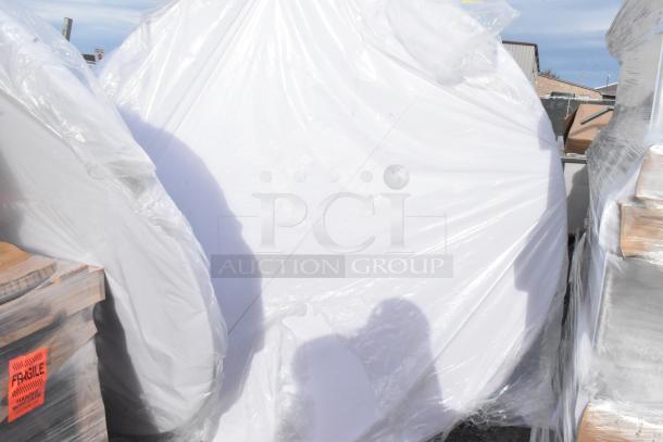 Two brand new white round folding tables wrapped in plastic, labeled "SCRATCH AND DENT." Includes "FRAGILE" tag.