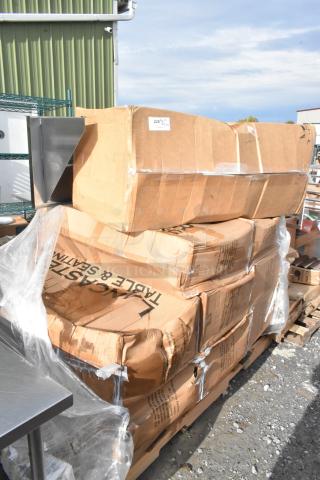 6 new scratch and dent boxes of 4 Lancaster Table & Seating white folding chairs with gray frame in original packaging.