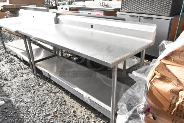 Win-holt stainless steel table with undershelf and backsplash. Excellent condition, ideal for kitchens or commercial use.