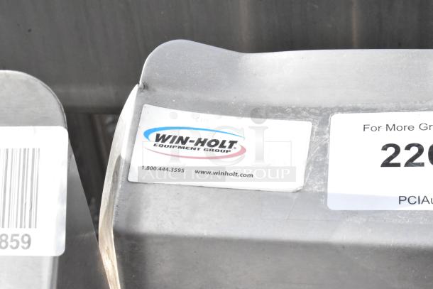 Win-holt stainless steel table with under shelf and back splash, featuring a label with contact details and branding.