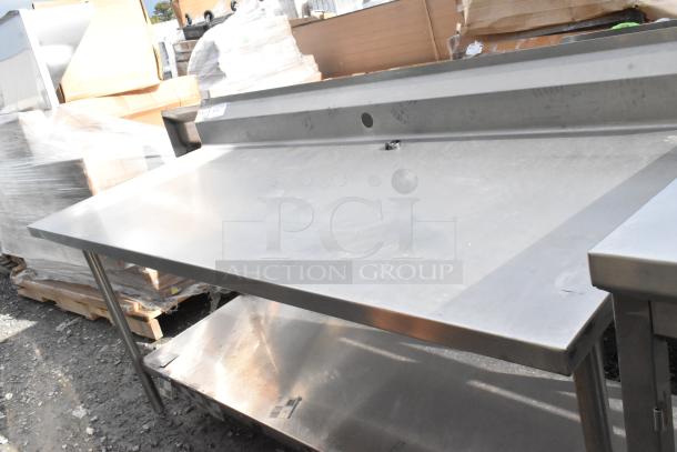 Win-holt stainless steel table with under shelf and backsplash, in good condition, suitable for commercial kitchens.