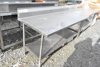 Win-holt stainless steel table with under shelf and back splash, light wear, sturdy construction, ideal for commercial use.