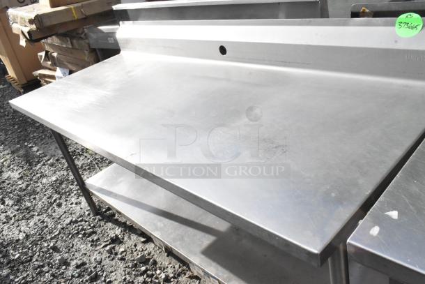 Win-holt stainless steel table with under shelf and backsplash, good condition, visible surface scratches, marked "373665".