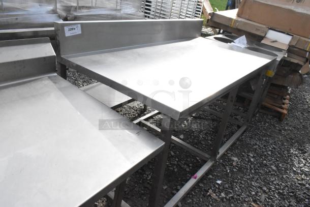 Win-holt stainless steel table with backsplash, sturdy build, slightly used condition, ideal for commercial kitchens.