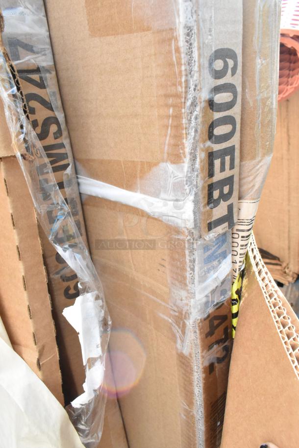 Cardboard boxes labeled "600EBTM42" and "SMS9274" containing scratch and dent items, wrapped in plastic.