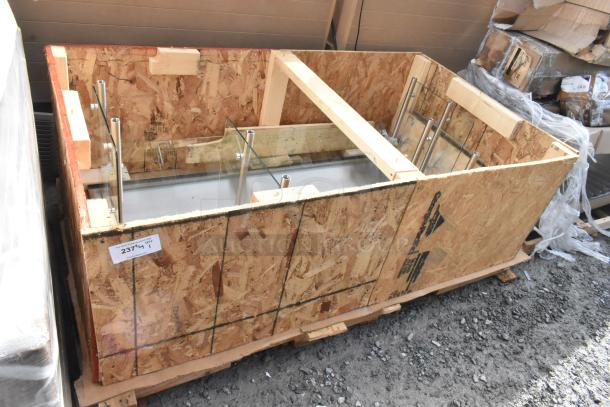 Crate containing 2 brand new sneeze guards with scratch and dent, visible metal supports and glass panels, labeled "2374/17".