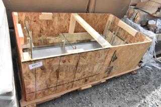 Crate containing 2 brand new sneeze guards with scratch and dent, visible metal supports and glass panels, labeled "2374/17".