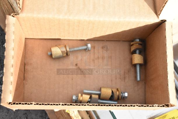 Open cardboard crate containing mounting hardware for two brand new sneeze guards. Condition: scratch and dent.