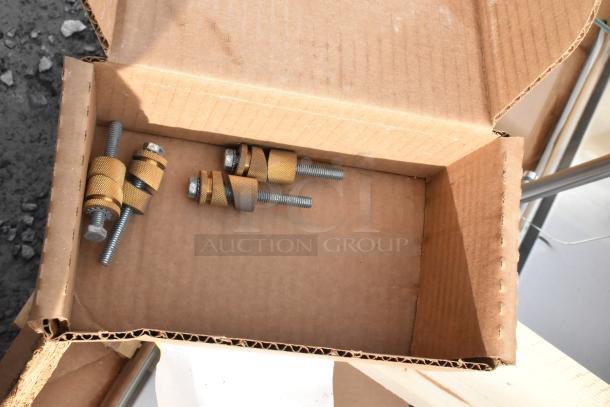 Crate containing parts for 2 brand new sneeze guards, scratch and dent condition, robustly packaged in a cardboard box.