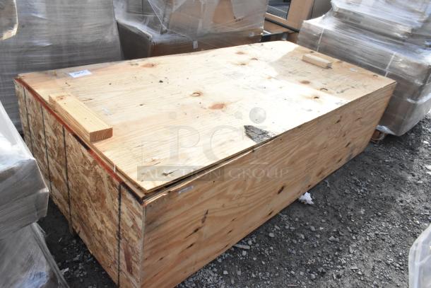 Wooden shipping crate labeled "Brand New Scratch and Dent." Shows minor surface marks; closed, sealed. Suitable for storage or transport.