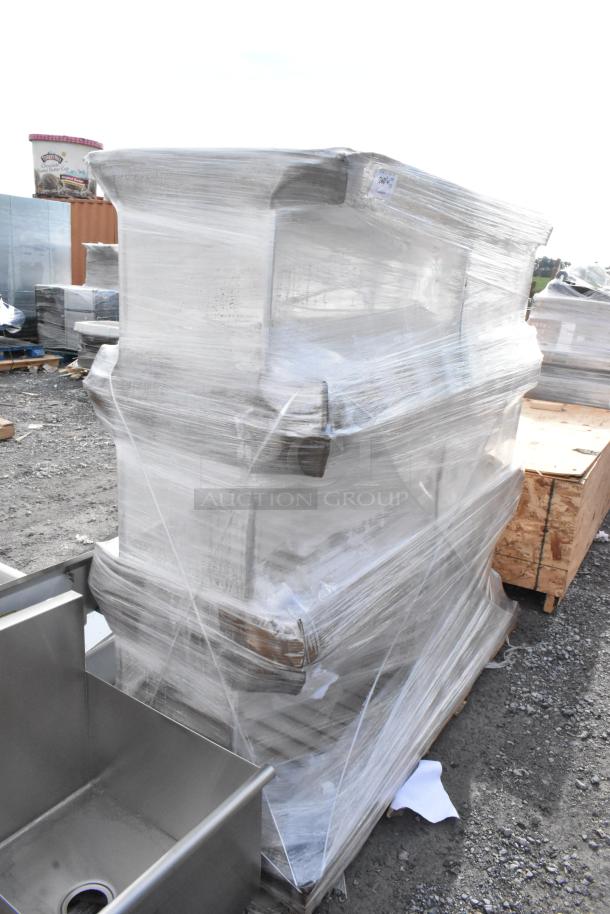 Three brand new metal pan racks, scratch and dent condition, wrapped in plastic, ready for auction.