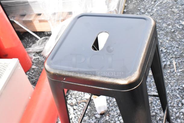 Black metal Tolix style bar stool, brand new with minor scratches. Square seat with handle cutout. Sold as a set of four.