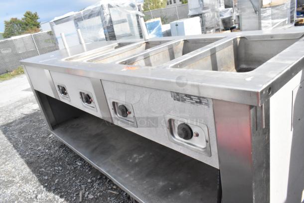 Seco stainless steel 4-bay steam table with under shelf, 208 volts, commercial grade. Fair condition, minor surface wear.