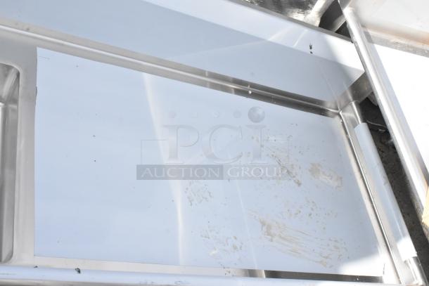 Brand new Regency 600DDT72R 16 gauge 6' soiled dish table with right drainboard. Scratch and dent condition visible.