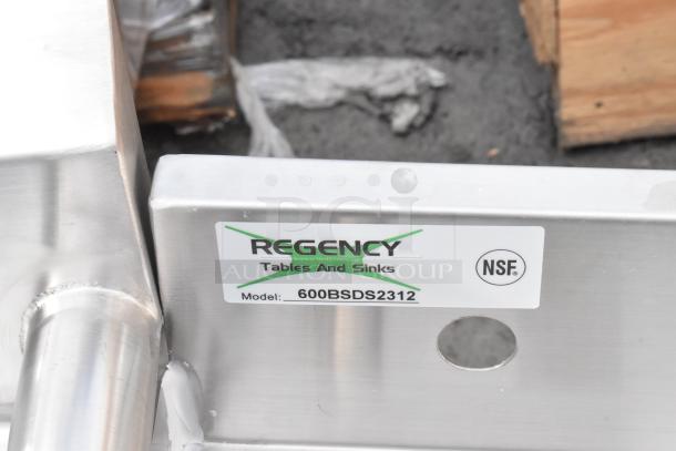 BRAND NEW Regency 600BSDS2312 12"x23" stainless steel blender station with minor scratches, NSF certified label visible.