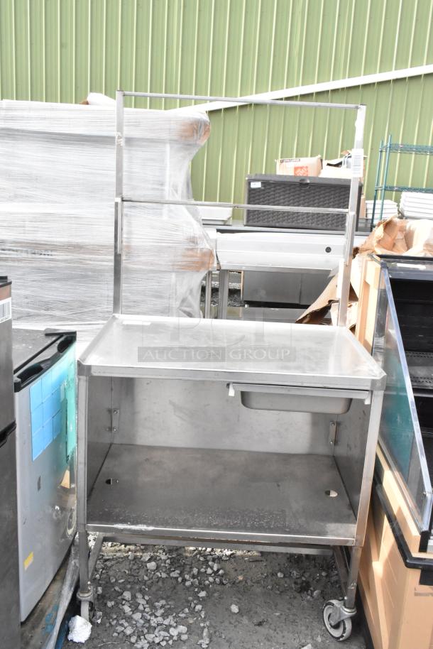 Winholt stainless steel cart by Killion, featuring a drawer, under shelf, and commercial casters. Good condition.