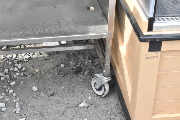 Winholt stainless steel cart by Killion with drawer, undershelf, and commercial casters. Visible wear on surface.