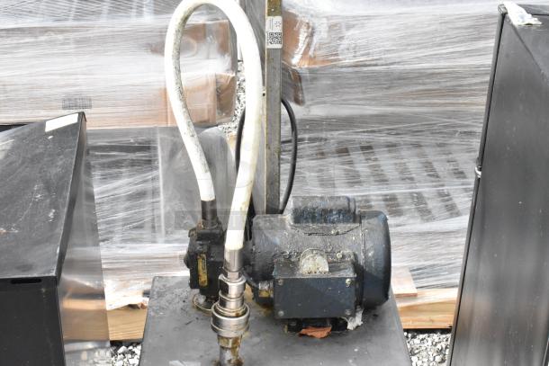 Metal commercial portable filter for fryer oil, item 402. Runs on 120 volts, 1 phase. Visible wear, industrial setting.