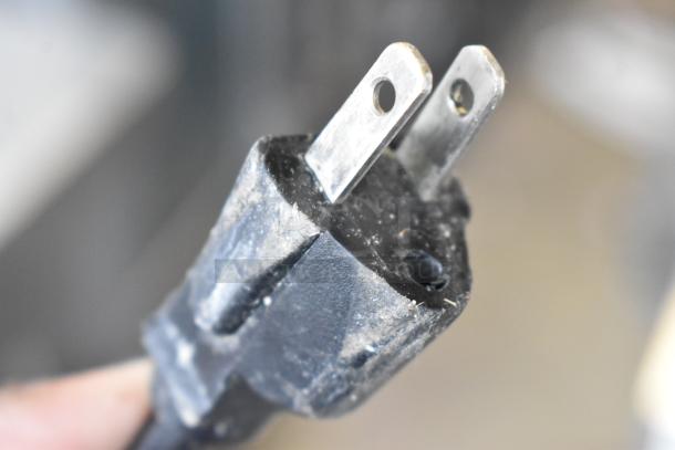 Close-up of a worn electrical plug on a Robot Coupe CL50 Ultra Series E commercial food processor. 120 volts, 1 phase.