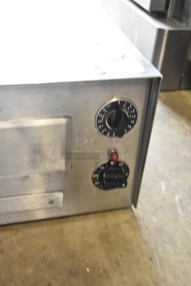 Wisco 560 stainless steel countertop pizza oven, showing control knobs. 120 volts, 1 phase, commercial use.