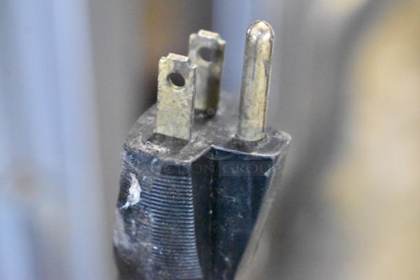 Close-up of a three-prong plug for the APW Wyott BW-20 metal warming drawer, 120 volts, 1 phase.