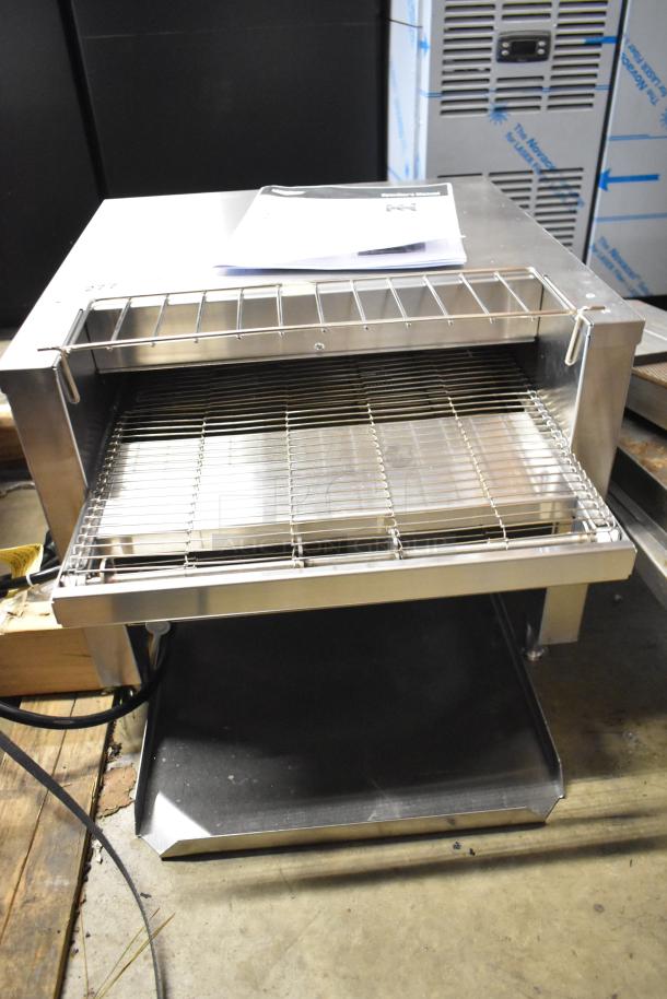 Brand new Vollrath JT2000 conveyor toaster, 208 volts, with 1 1/2" opening, visible manual on top, minor scratches.