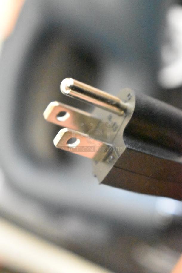 Close-up of a three-prong plug from an AvaMix 928IBHD21 immersion blender, highlighting electrical compatibility.