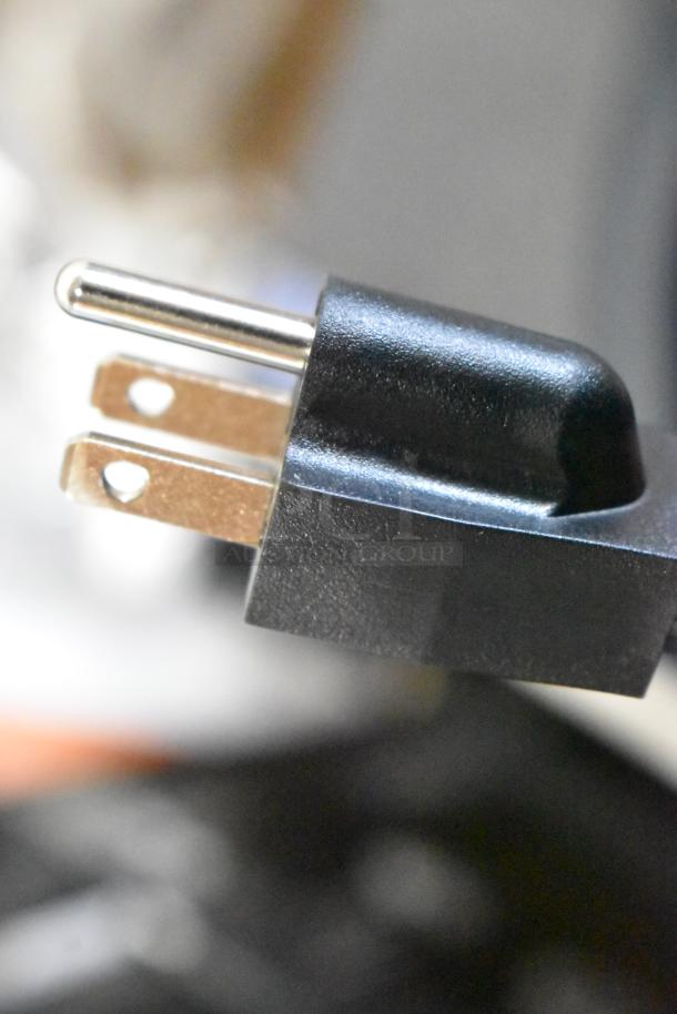 Close-up of the plug from a brand new AvaMix 928IBHD12 Heavy-Duty Immersion Blender, showing the standard prongs.