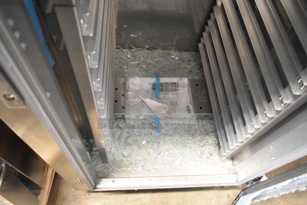 BRAND NEW Metro C569-SFC-L heated holding cabinet shown with broken glass inside. Features steel interior on commercial casters. 120V, 1 Phase.