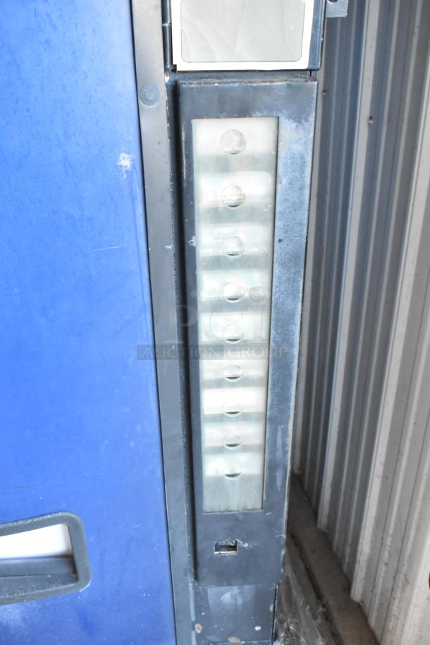 Dixie-Narco DN600E-MC/SII-9 vending machine with credit card acceptor, 115V, 1 phase. Visible wear on the metal surface.