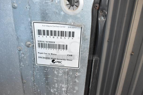 Dixie-Narco DN600E-MC/SII-9 vending machine with credit card acceptor, 115V, showing serial number and Pepsi branding.