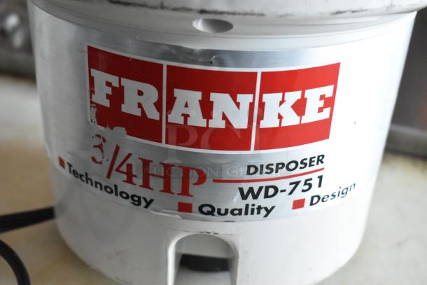 Franke Little Butler Waste Disposer, model WD-751, 3/4 HP. Silver finish with red and black branding. 115 Volts, 1 Phase.