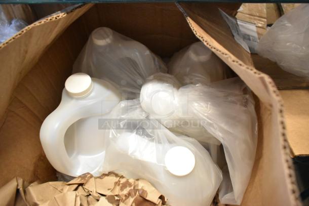 7 various items in a cardboard box, including Betco AF315 Disinfectant Cleaner. Items are in sealed plastic bags.