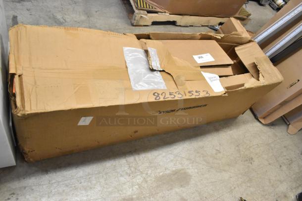 Large cardboard box labeled "Xyso/Warren" containing lights, with a torn opening and visible packaging labels, in used condition.
