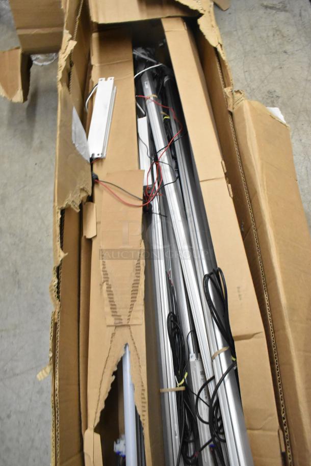 Box of Lights, includes various lighting fixtures and wiring. Items appear new, packaged in a torn cardboard box.