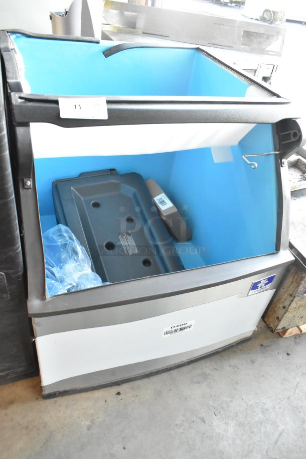 Brand new Manitowoc D400 stainless steel ice bin, 30", 365 lbs capacity, with minor scratches and dents visible.