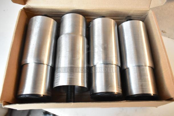 Box containing four cylindrical metal components with threaded ends, likely shipping or structural rods.