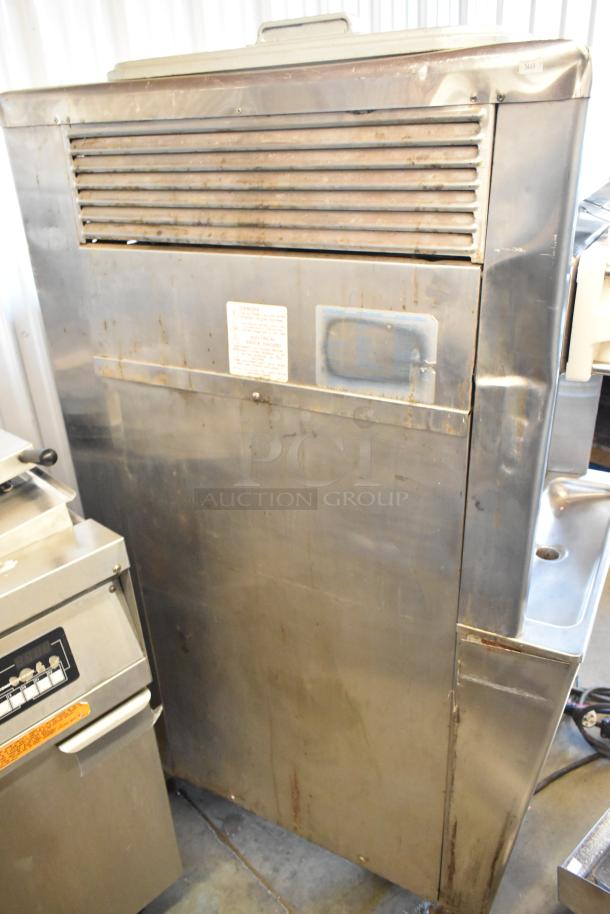 Taylor stainless steel commercial floor-style, water-cooled, 2-flavor soft serve ice cream machine on casters. 208/240V, 3 phase.