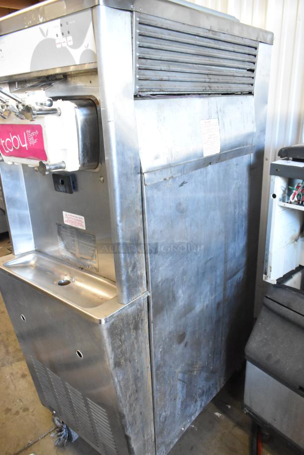 Taylor stainless steel commercial soft serve ice cream machine, 2 flavors with twist, water-cooled, on casters, 208/240V, 3 phase.