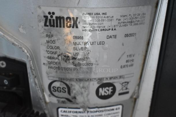 2021 Zumex Multifruit LED juicer base, silver, 115V, 1 phase, visible label with model details and certifications.