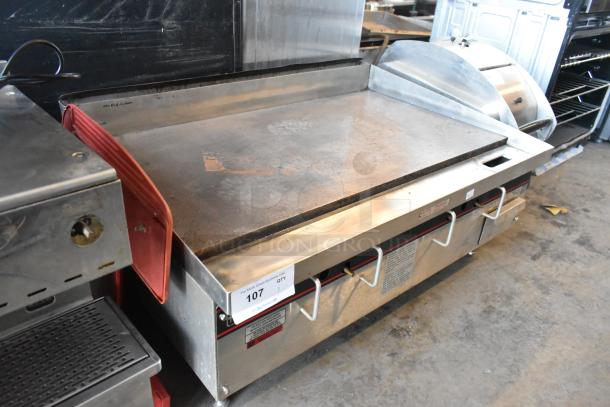 APW Wyott stainless steel commercial gas flat top griddle, countertop model, with visible wear, auction lot 107.