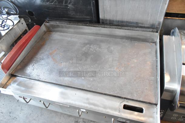 APW Wyott stainless steel gas countertop griddle, used condition, flat top surface, model details on front panel.