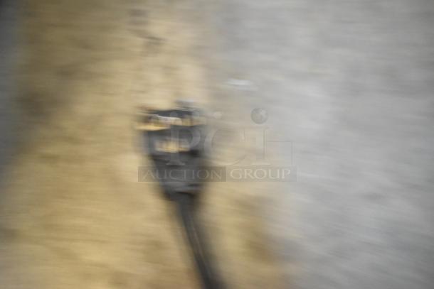 Blurry image likely showing the cord or plug of a Panasonic NE-1757R Commercial Microwave. 208 Volts, 1 Phase.