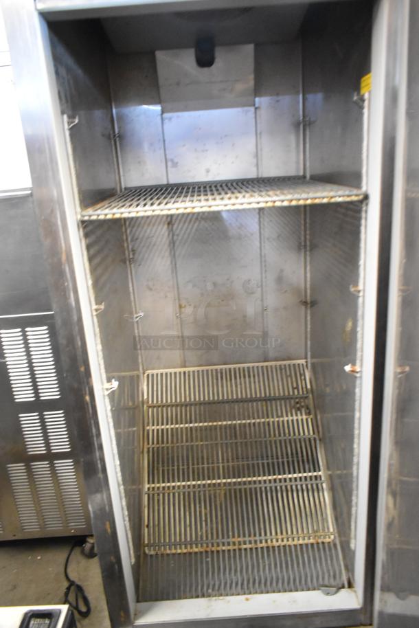 Fagor QVF-1 stainless steel commercial single-door reach-in freezer, 115V, 1 phase, internal shelves visible.